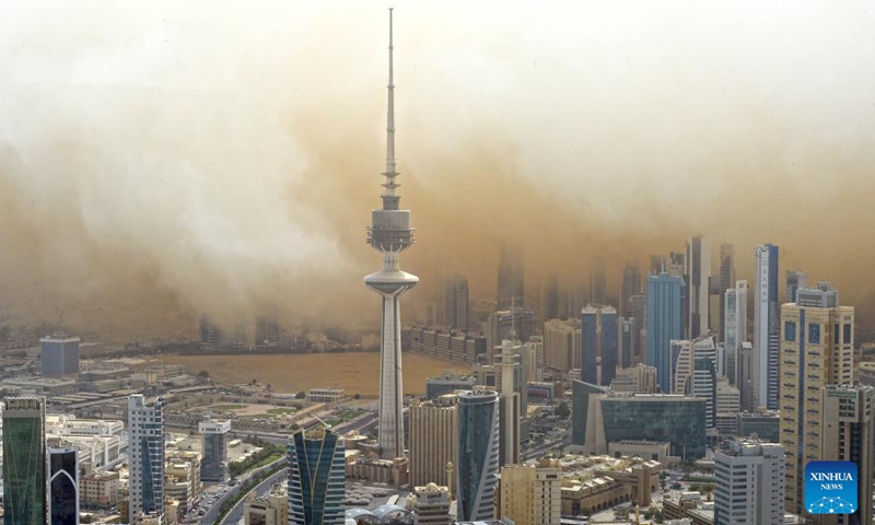 Photo taken on May 23, 2022 shows buildings shrouded in strong dust storm in Kuwait City, Kuwait.Photo:Xinhua