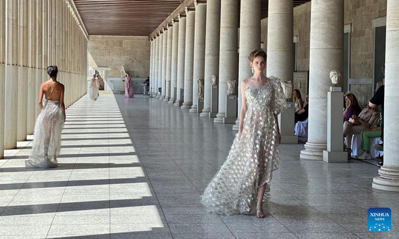 Models present creations of Greek fashion designer Vassilios Kostetsos at the Stoa of Attalos in ancient Agora of Athens, Greece, on May 23, 2022.Photo:Xinhua
