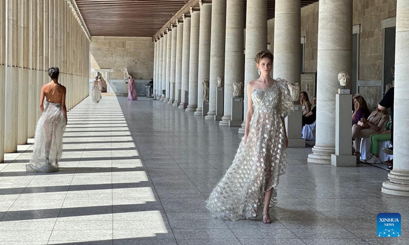 Models present creations of Greek fashion designer Vassilios Kostetsos at the Stoa of Attalos in ancient Agora of Athens, Greece, on May 23, 2022.Photo:Xinhua