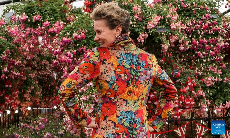 A woman poses at the RHS (Royal Horticultural Society) Chelsea Flower Show in London, Britain, on May 24, 2022. The annual RHS Chelsea Flower Show opened to the public on Tuesday.(Photo: Xinhua)