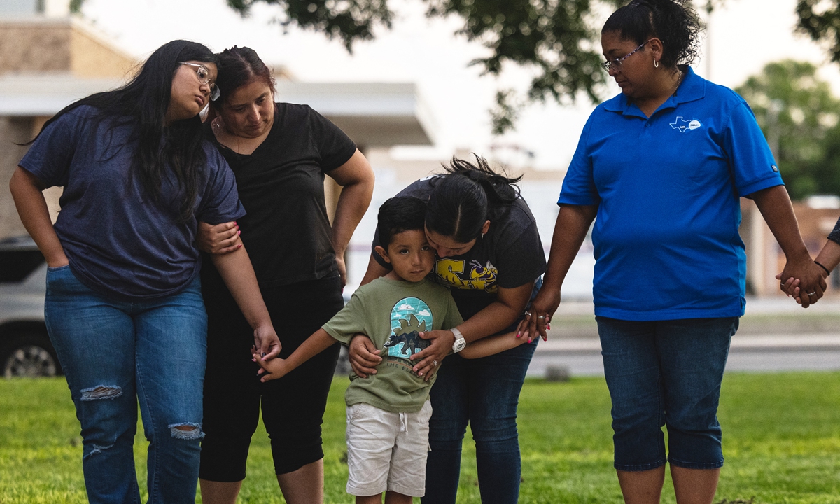 Members of the community gather at the City of Uvalde Town Square for a prayer vigil in the wake of a mass shooting at Robb Elementary School on May 24, 2022 in Uvalde, Texas. According to media reports, 19 students and 2 adults were killed before the gunman was fatally shot by law enforcement. Photo: AFP