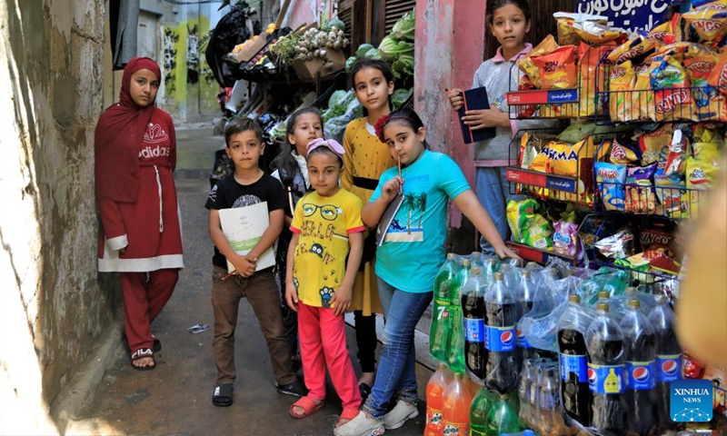 Children pose for a photo in an alley in the Mar Elias refugee camp in Beirut, Lebanon, May 23, 2022.(Photo: Xinhua)
