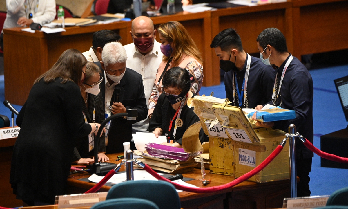Officials from Congress inspect Certificate of Canvass (CoC) from the provinces during the official canvassing of votes for the president and vice president in Congress in Quezon City, suburban Manila, the Philippines on May 25, 2022. The total number of votes canvassed is about 40.6 million, says INQUIRER.net. Photo: AFP