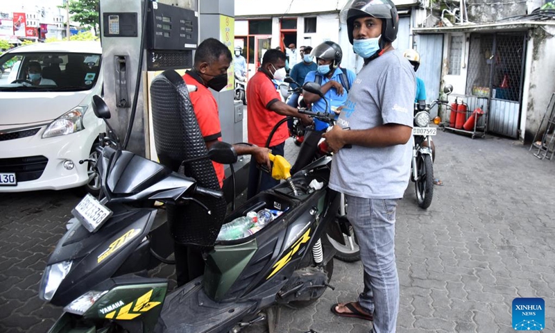 People fuel motorcycles at a gas station in Colombo, Sri Lanka, on May 24, 2022. Sri Lanka's state-owned Ceylon Petroleum Corporation has once again increased its fuel prices from Tuesday morning as the fuel shortage continues in the country.(Photo: Xinhua)