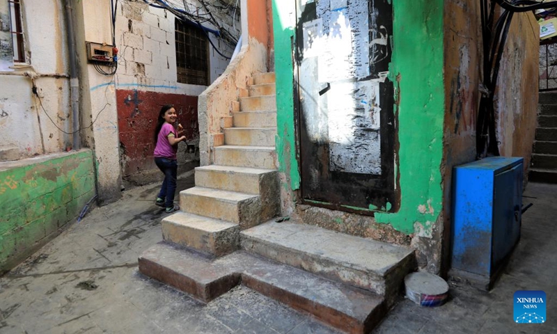 A girl walks in an alley in the Mar Elias refugee camp in Beirut, Lebanon, May 23, 2022.(Photo: Xinhua)