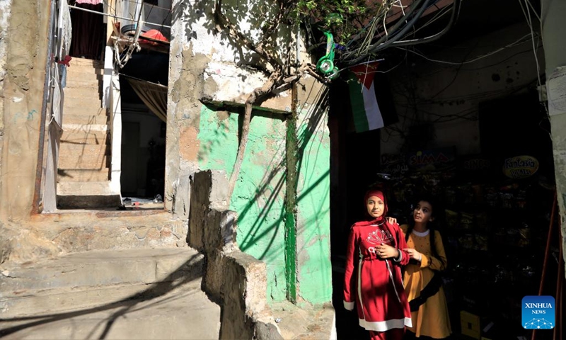 Two girls are seen in an alley in the Mar Elias refugee camp in Beirut, Lebanon, May 23, 2022.(Photo: Xinhua)