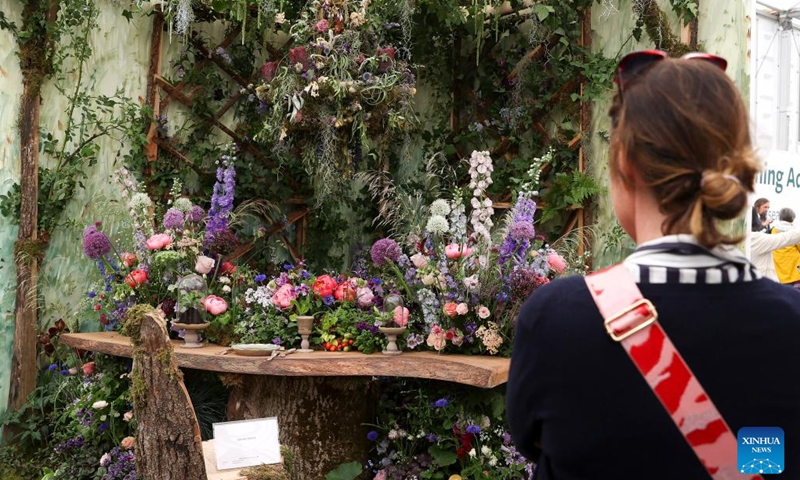 A woman enjoys a floral display at the RHS (Royal Horticultural Society) Chelsea Flower Show in London, Britain, on May 24, 2022. The annual RHS Chelsea Flower Show opened to the public on Tuesday.(Photo: Xinhua)