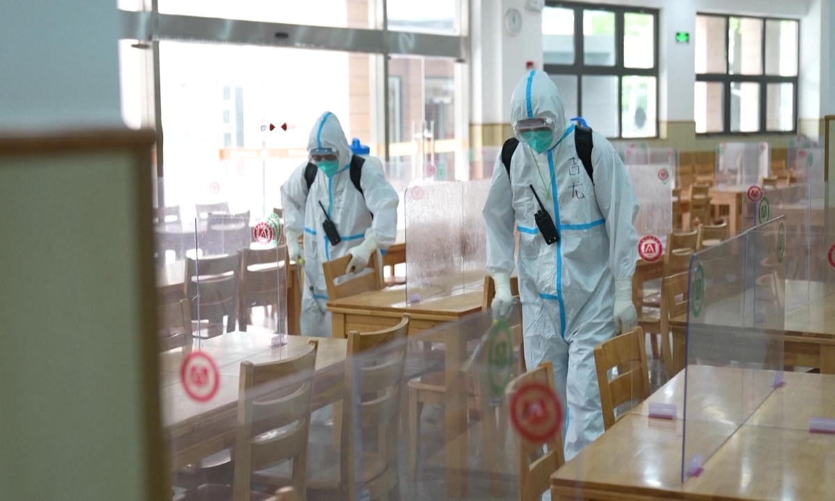 Working staff disinfect a school on May 10 to prepare for school reopening in June in Shanghai. Photo: VCG