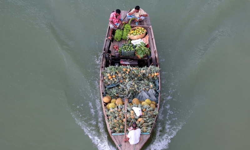 A boat loaded with fruits is seen at a floating market in Rangamati, Bangladesh, on May 20, 2022.(Photo: Xinhua)