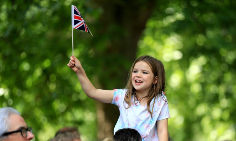 A girl watches the Trooping the Colour parade in celebration of Britain's Queen Elizabeth II's Platinum Jubilee, in London, Britain, on June 2, 2022. (Xinhua/Li Ying)