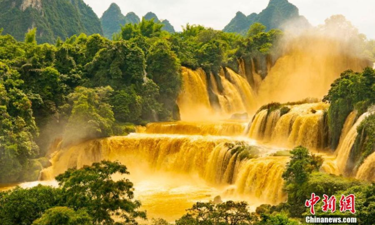 Detian waterfall forms a rare golden waterfall under the sun light due to the soared water volume. May 26, 2022. Photo:China News Service