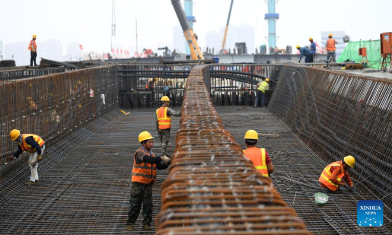 Constructors work at the construction site of a bridge, which is a part of a mega water diversion project to divert water from the Yangtze River to the Huaihe River, in east China's Anhui Province, June 3, 2022. (Xinhua/Liu Junxi)