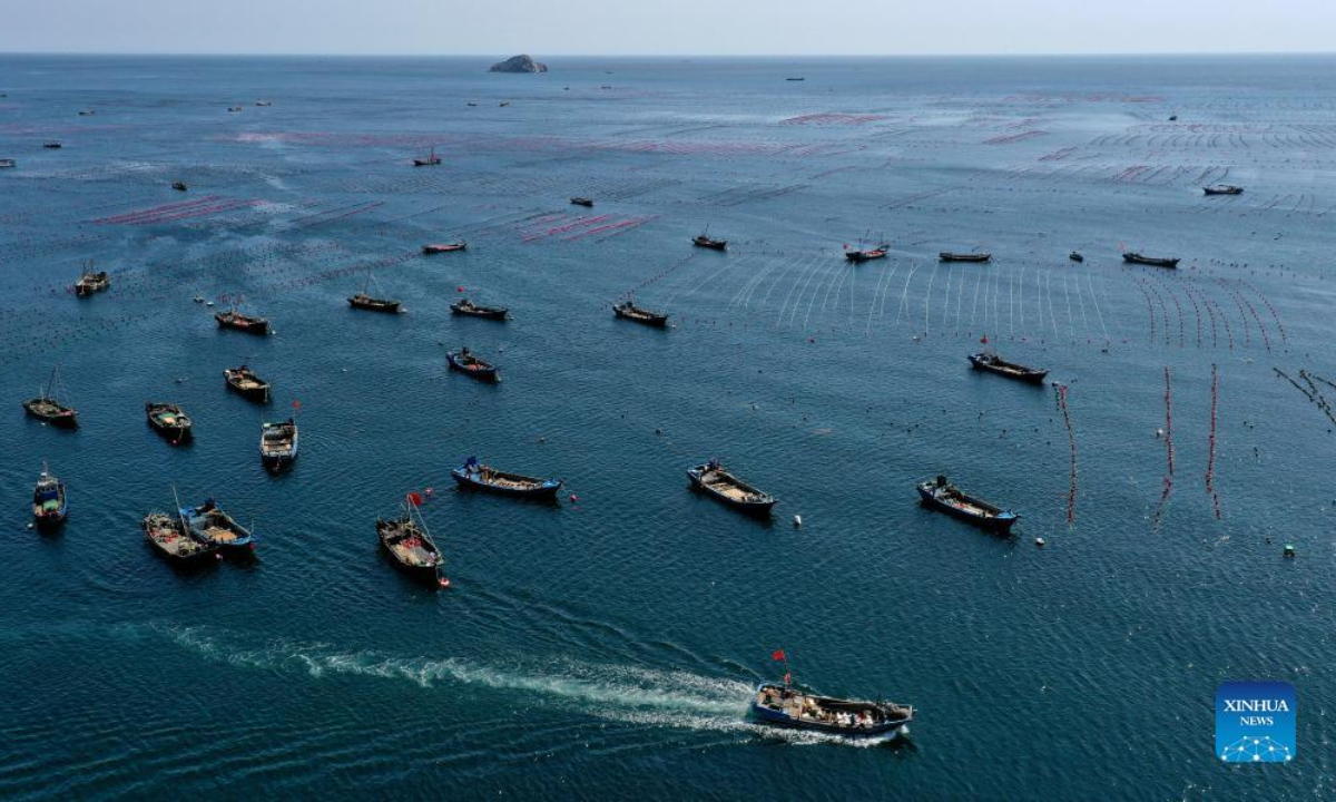 Aerial photo taken on May 31, 2022 shows fishermen working at a marine ranch in Haiyangdao Township of Changhai County in Dalian, northeast China's Liaoning Province. More than 10 state-level marine ranch demonstration zones have been approved in Changhai County since 2016. Photo:Xinhua
