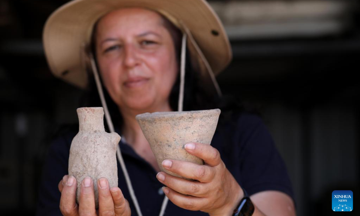 A staff member of the Israel Antiquities Authority (IAA) works at an excavation site next to Arbel stream near Tiberias, Israel, on May 26, 2022. Israeli archaeologists have discovered a well-preserved ancient agricultural farmstead, dated back to 2,100 years ago, the Israel Antiquities Authority (IAA) said on Wednesday. Photo:Xinhua