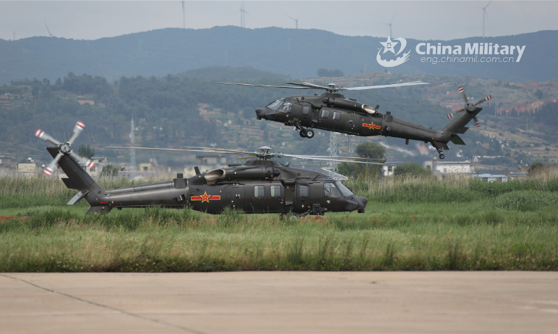 Attack helicopters attached to a brigade under the PLA 75th Group Army execute hovering inspections during a flight training exercise on May 26, 2022. (eng.chinamil.com.cn/Photo by Li Chunguo)