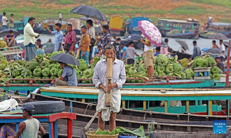 A vendor waits for customers at a floating market in Rangamati, Bangladesh, on May 22, 2022.(Photo: Xinhua)