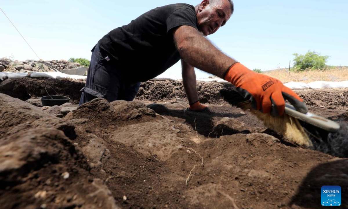 A staff member of the Israel Antiquities Authority (IAA) works at an excavation site next to Arbel stream near Tiberias, Israel, on May 26, 2022. Israeli archaeologists have discovered a well-preserved ancient agricultural farmstead, dated back to 2,100 years ago, the Israel Antiquities Authority (IAA) said on Wednesday. Photo:Xinhua