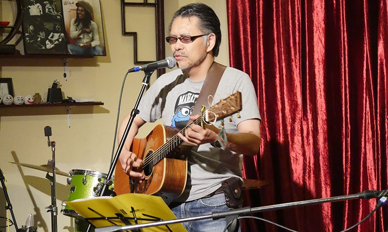 Grandpa Mori plays a guitar. Photo: Courtesy of Grandpa Mori