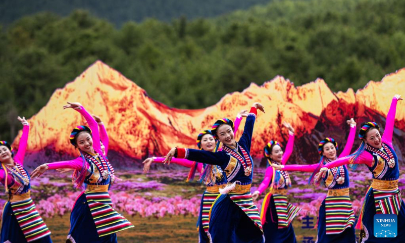 Actresses perform traditional dance at a horse racing festival held in Shangri-La, Deqen Tibetan Autonomous Prefecture, southwest China's Yunnan Province, June 3, 2022. (Xinhua/Cao Mengyao)