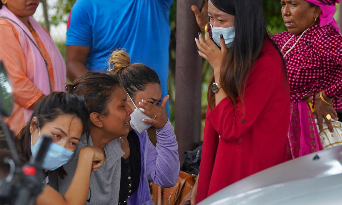 Family members and relatives of passengers on board the Twin Otter aircraft operated by Tara Air, weep outside the airport in Pokhara, Nepal on May 29, 2022. A passenger plane with 22 people on board went missing in Nepal on May 29, 2022, as poor weather hampered a search operation. Photo: AFP