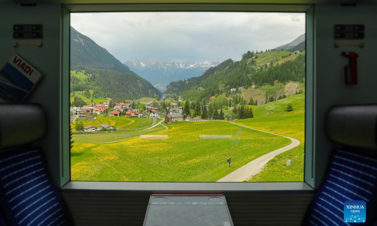 Photo taken on May 22, 2022 shows a view through the window on a train that runs on the Rhaetian Railway in the Albula/Bernina landscapes in Switzerland. The Rhaetian Railway in the Albula/Bernina landscapes was included in the UNESCO World Heritage List in 2008. Photo:Xinhua