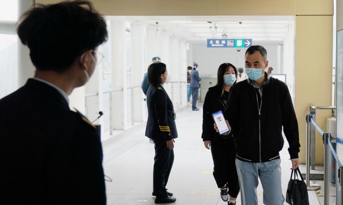 A passenger shows his health QR code before entering a subway station in Beijing, capital of China, May 17, 2022. Photo:Xinhua