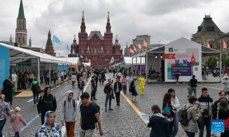 People attend the annual book festival on the Red Square in Moscow, Russia, on June 3, 2022. (Photo by Alexander Zemlianichenko Jr/Xinhua)