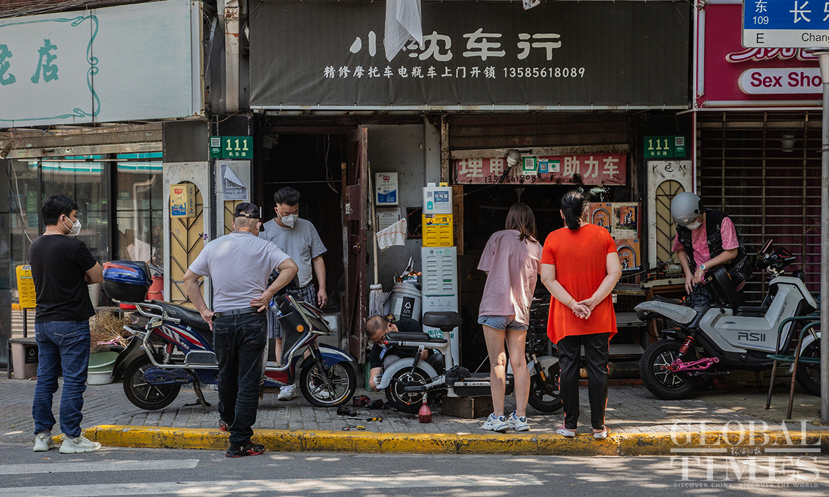 A store to fix motorbikes and electric scooters opens to customers in downtown Shanghai on May 31. Photo: Wu Shiliu