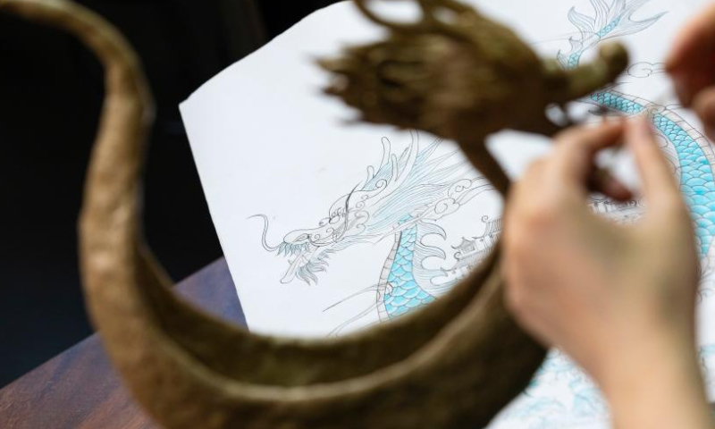 Craftswoman Yan Hong cuts cans to make a dragon boat at a workshop in Pidu District of Chengdu City, southwest China's Sichuan Province, May 24, 2022. Yan Hong, a craftswoman and a lover of traditional Chinese culture, made a dragon boat decoration with cans as the main material ahead of the Dragon Boat Festival.
Yan has made more than 200 pieces of handicrafts in traditional Chinese style since 2018, some of which were made of material available in daily life such as cans and curtain gauze. (Xinhua/Shen Bohan)