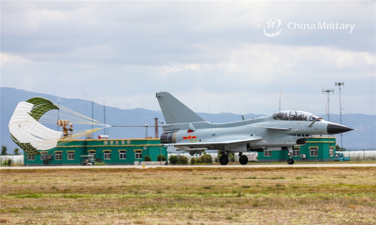 A fighter jet attached to an air force aviation brigade under the PLA Southern Theater Command deploys its drogue parachute to slow down after landing in the real-combat flight training on May 11, 2022. (eng.chinamil.com.cn/Photo by Li Zishao)