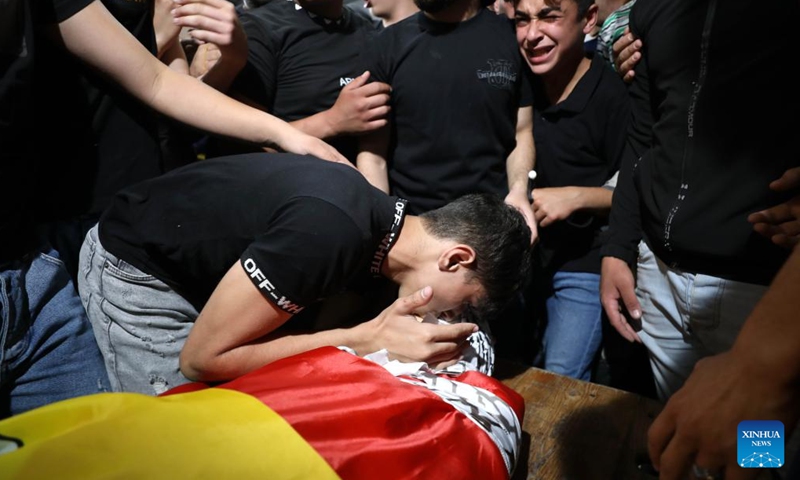 Relatives of Ghaith Yamin mourn during his funeral in the West Bank city of Nablus, on May 25, 2022. A Palestinian teenager was killed and more than 90 others were wounded early on Wednesday during clashes with Israeli soldiers near the northern West Bank city of Nablus, the Palestinian Ministry of Health said in a statement. The statement said Ghaith Yamin, 16, was killed after he was shot in the head by Israeli soldiers during clashes in Nablus. (Photo: Xinhua)