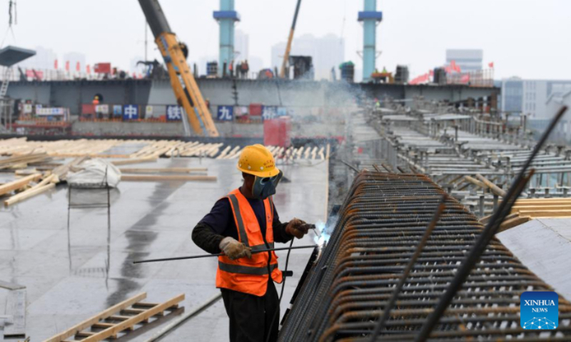 A constructor works at the construction site of a bridge, which is a part of a mega water diversion project to divert water from the Yangtze River to the Huaihe River, in east China's Anhui Province, June 3, 2022. (Xinhua/Liu Junxi)