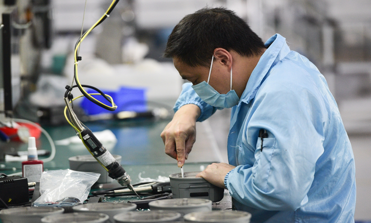 A worker assembles equipment at a firm located in Qingpu district, Shanghai on May 21. Photo: VCG