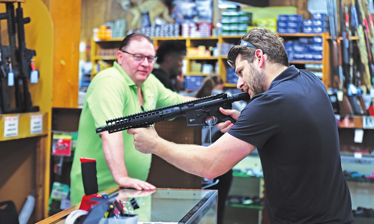 Firearms and ammo are on display as a buyer visits Bob's Little Sport Gun Shop in Glassboro, New Jersey, on May 26, 2022. The US National Rifle Association is set to hold its annual meeting on Friday even though 19 children were shot and killed in Texas three days ago. Photo: IC