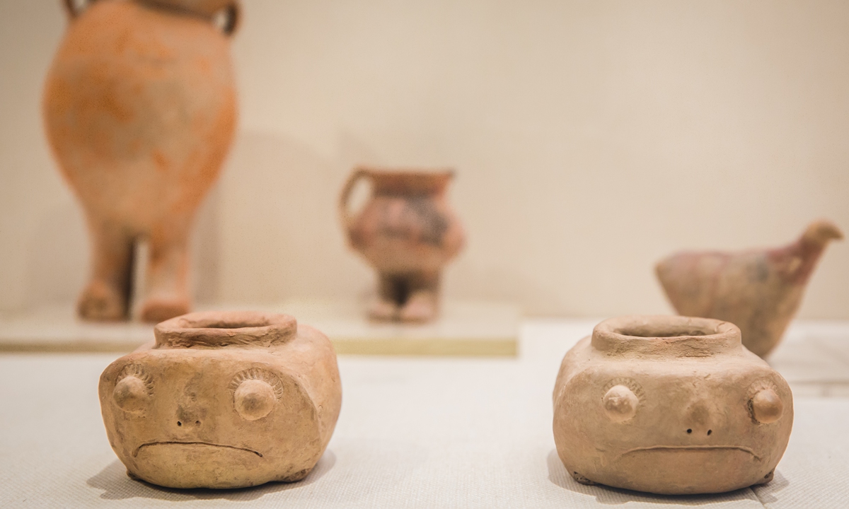 Top: Jade objects (left) and a stone carving on display at the Liangzhu Museum Inset: Pots on display at the Gansu Provincial Museum Photos: VCG