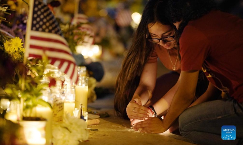 People attend a vigil to mourn for victims of a school mass shooting at Town Square in Uvalde, Texas, the United States, May 29, 2022. At least 19 children and two adults were killed in a shooting at Robb Elementary School in the town of Uvalde, Texas, on Tuesday. (Xinhua/Wu Xiaoling)