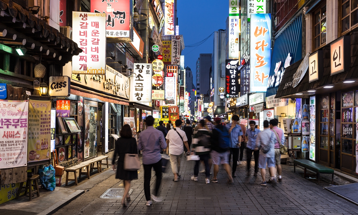 People walk through a street in Seoul, South Korea. Photo: IC