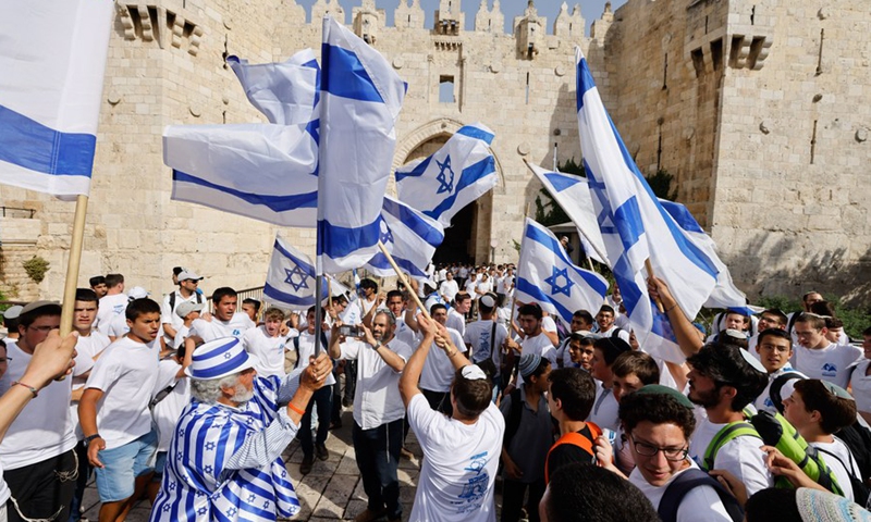 People take part in the flag march to mark Jerusalem Day outside the Damascus Gate in the Old City of Jerusalem, on May 29, 2022.Photo:Xinhua