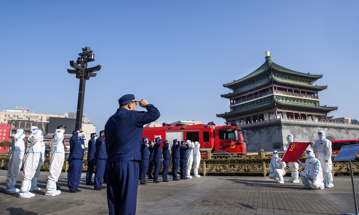 CPC members from the Shaanxi Provincial Fire Rescue Corps vow to the flag of the CPC while they are fighting the COVID-19 outbreak in Xi'an, capital of Shaanxi in January 2022. Photo: IC