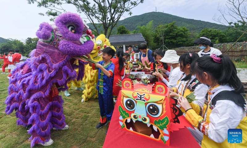 Children attend activities celebrating the upcoming Dragon Boat Festival at a farm in Huzhou City, east China's Zhejiang Province, May 31, 2022. The Dragon Boat Festival would fall on June 3 this year.(Photo: Xinhua)