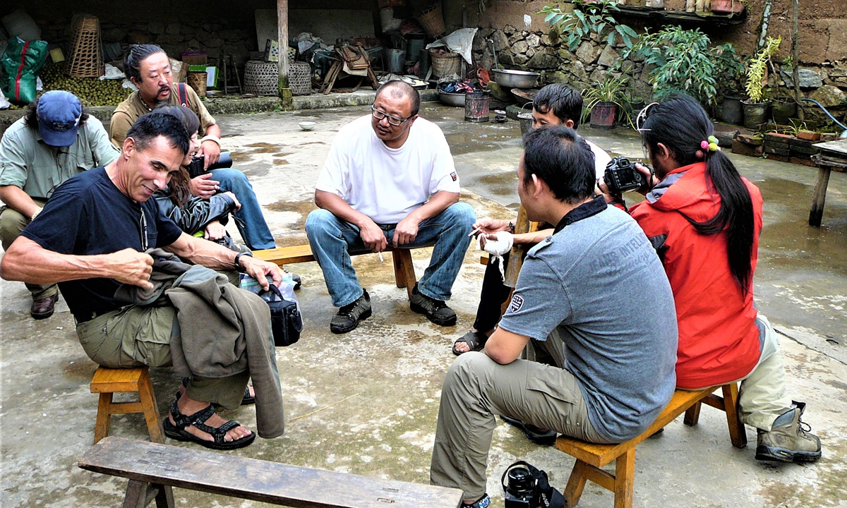 US expeditor Clayton Kuhles with local villagers during a mission to search the crash site of CNAC #60, a plane crached inside Southwest China's Yunann Province in 1942 during 'Flying Tigers' mission in World War II. Photo: Courtesy of MIA Recoveries, Inc.