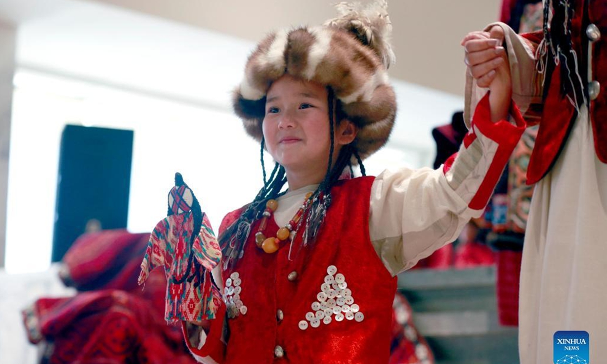 A girl participates in a fashion show displaying clothes of nomadic style to celebrate the International Children's Day in Bishkek, Kyrgyzstan, June 1, 2022. (Photo by Roman/Xinhua)