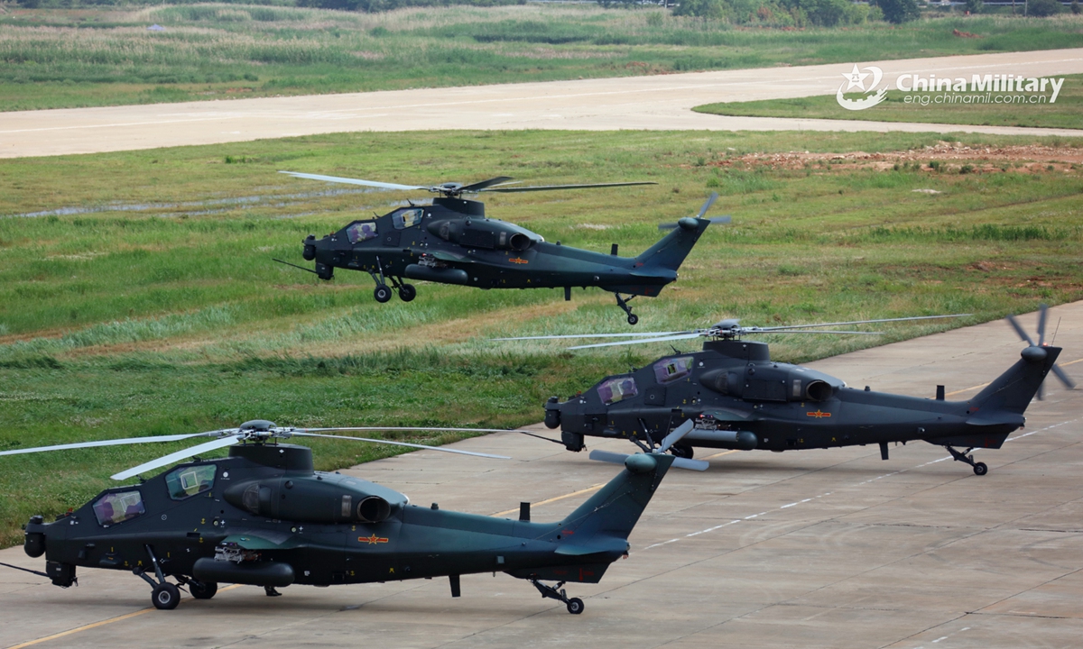A group of attack helicopters attached to a brigade under the PLA 75th Group Army execute hover checks before leaving for a flight training task on May 25, 2022. (eng.chinamil.com.cn/Photo by Li Chunguo)