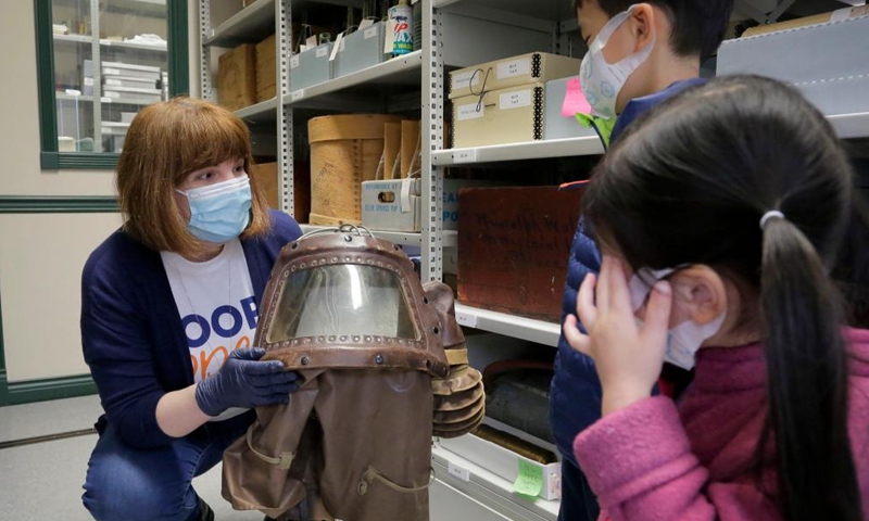 A staff member shows a gas mask at Richmond Museum's artifact storage warehouse during the Doors Open Richmond event in Richmond, British Columbia, Canada, on June 4, 2022.Photo:Xinhua