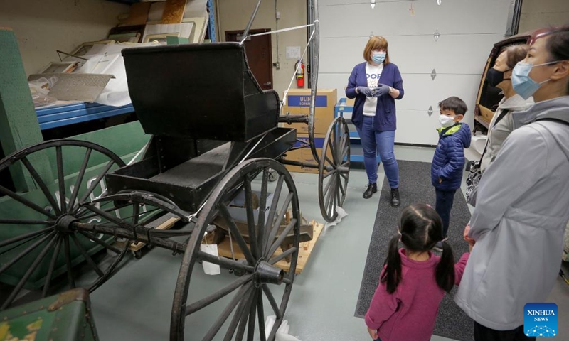 People look at a carriage made in 1900s at Richmond Museum's artifact storage warehouse during the Doors Open Richmond event in Richmond, British Columbia, Canada, on June 4, 2022.Photo:Xinhua
