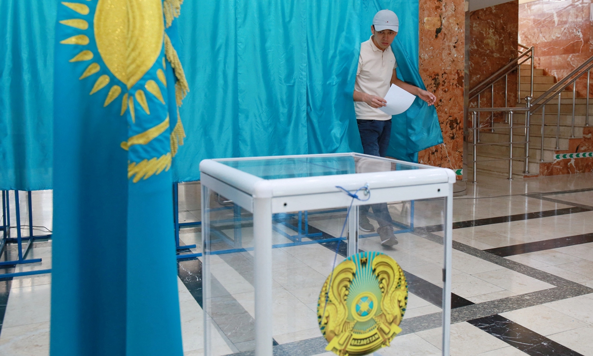 A man leaves a polling booth on his way to cast his ballot at a polling station as part of the vote for a referendum to overhaul the constitution in Almaty, Kazakhstan on June 5, 2022. Photo: AFP