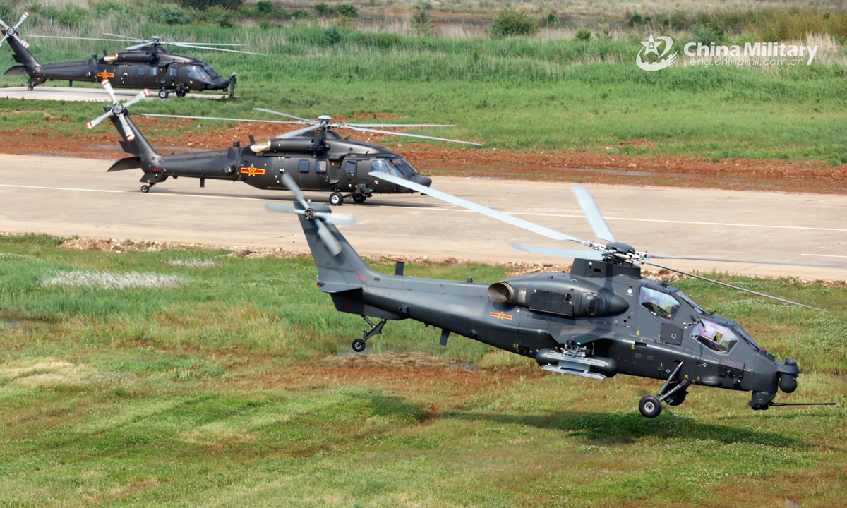 A group of attack helicopters attached to a brigade under the PLA 75th Group Army execute hover checks before leaving for a flight training task on May 25, 2022. (eng.chinamil.com.cn/Photo by Li Chunguo)