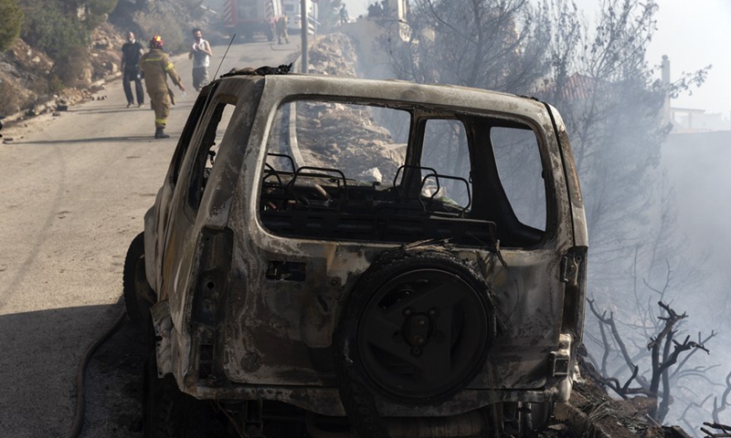 A vehicle burned down in a wildfire is seen in Voula, a southern suburb of Athens, Greece, on June 4, 2022.Photo:Xinhua