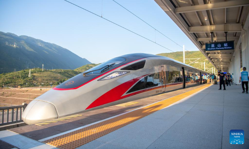 A bullet train stops at the Wushan Railway Station in Wushan County, southwest China's Chongqing Municipality, June 13, 2022, during a trial operation of the Chongqing-Wushan section of the high-speed railway linking Chongqing and Zhengzhou, capital of central China's Henan Province. The Zhengzhou-Chongqing High-speed Railway will be fully operational in late June, cutting the travel time between the two cities from 8 hours to 4 hours and upgrading the high-speed railway network in central China and southwest China. (Xinhua/Tang Yi)