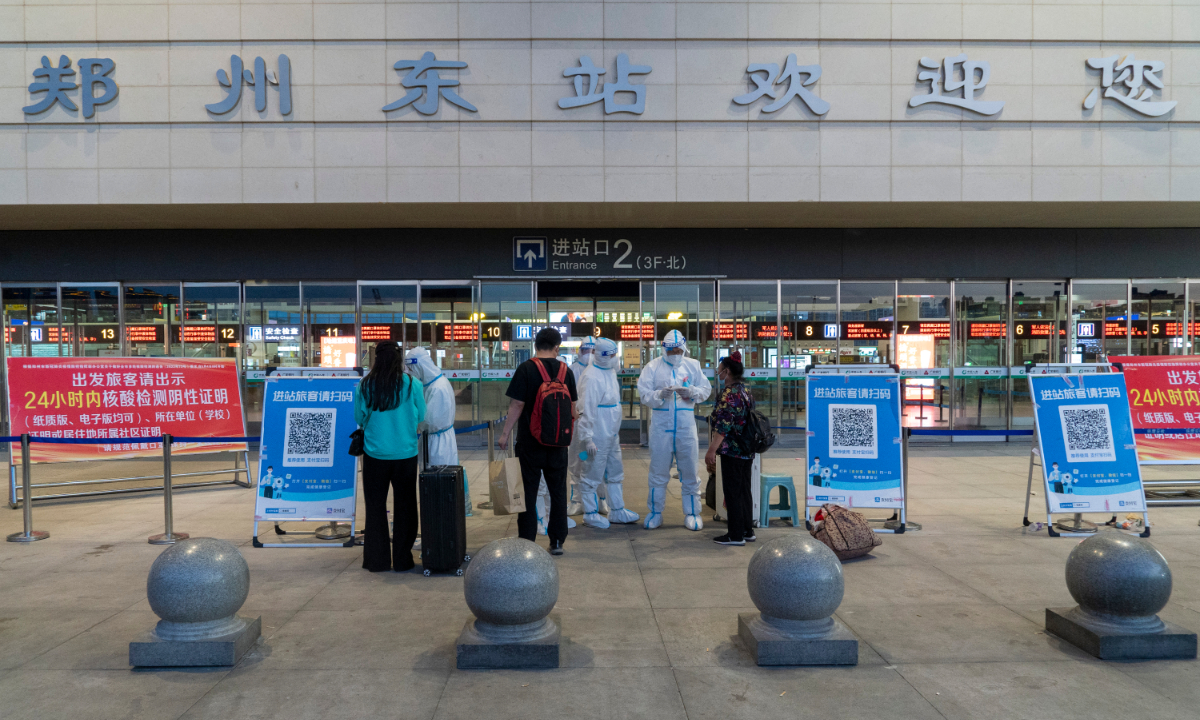 Staff check passengers' health codes and nucleic acid test results at a railway station in Zhengzhou, Central China's Henan Province, on May 4. Photo: VCG